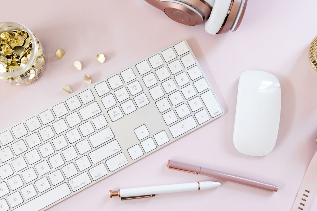 keyboard on pink flatlay feminine stock photo