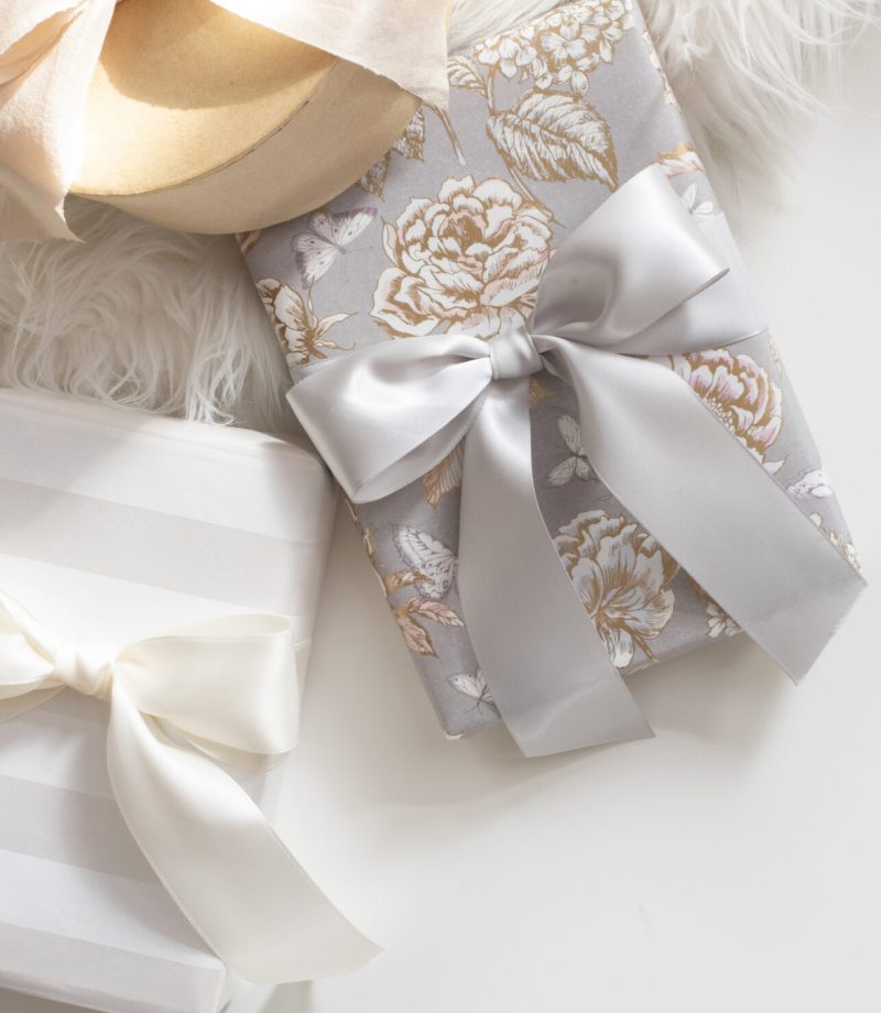 gifts with ribbons on white background with a fur rug